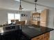 Bright dining area featuring a wicker hutch, pendant lights, and a table set for a meal, enhancing the home's cozy atmosphere at 24505 Snail Rd, Astor, FL 32102