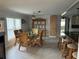 This spacious dining room features wicker furniture, tile flooring, and modern lighting at 24505 Snail Rd, Astor, FL 32102