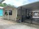 View of the property showcasing its covered parking and cozy exterior at 24505 Snail Rd, Astor, FL 32102