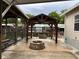 Outdoor gazebo and stone firepit offer relaxation and entertainment at 24505 Snail Rd, Astor, FL 32102