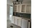Wet bar or kitchenette with white cabinets, tiled countertop, and mini-fridge at 24505 Snail Rd, Astor, FL 32102