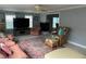 Cozy living room with plush seating, a fireplace, and ample natural light from large windows at 24505 Snail Rd, Astor, FL 32102
