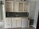 Charming wet bar featuring a mini-fridge, tiled backsplash, and open shelving for storage and display at 24505 Snail Rd, Astor, FL 32102