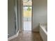 A bright bathroom with a shower and a bathtub, perfect for relaxation at 2470 Augusta Way, Kissimmee, FL 34746