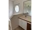 A well-lit bathroom featuring a vanity and large mirror at 2470 Augusta Way, Kissimmee, FL 34746