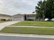 Charming single-story home with attached two-car garage and well-manicured lawn at 2470 Augusta Way, Kissimmee, FL 34746