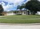 A well-kept home featuring an attached two-car garage with a large manicured lawn at 2470 Augusta Way, Kissimmee, FL 34746