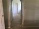 Hallway with tile flooring and multiple closets leading to the bedrooms at 2470 Augusta Way, Kissimmee, FL 34746