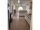 Open kitchen with tiled flooring, white cabinets, and stainless steel appliances at 2470 Augusta Way, Kissimmee, FL 34746