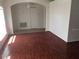 Cozy living room featuring gleaming hardwood floors and arched doorways at 2470 Augusta Way, Kissimmee, FL 34746
