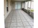 Enclosed patio with tile flooring and screen windows that bring in natural light at 2470 Augusta Way, Kissimmee, FL 34746