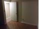 This bedroom features neutral walls, wood parquet floors and an open closet for storage at 2822 S Dean Rd, Orlando, FL 32825