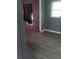 Bedroom featuring hardwood-style floors, window for light, and partially covered walls at 2822 S Dean Rd, Orlando, FL 32825
