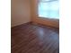 This bedroom features neutral walls and laminate wood-style flooring at 2822 S Dean Rd, Orlando, FL 32825