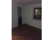 This bedroom features neutral walls, wood parquet floors and a window for natural light at 2822 S Dean Rd, Orlando, FL 32825