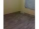 Bedroom featuring neutral walls, wood-look floors, and natural light at 2822 S Dean Rd, Orlando, FL 32825