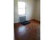 Bedroom with hardwood floors and a window overlooking the outside at 2822 S Dean Rd, Orlando, FL 32825