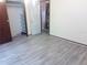 Bedroom with light hardwood-style flooring and a closet with shelving at 2822 S Dean Rd, Orlando, FL 32825
