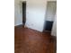 Empty bedroom with parquet flooring, door frames, and closet at 2822 S Dean Rd, Orlando, FL 32825