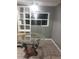 The dining room features a modern glass-topped table, stylish shelving, and natural light, creating a cozy ambiance at 2822 S Dean Rd, Orlando, FL 32825