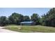 Charming home featuring a bright blue roof and neutral gray siding, nestled on a well-maintained lawn at 2822 S Dean Rd, Orlando, FL 32825