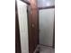 Hallway featuring wood-look flooring and a neutral painted door and wooden paneling on the walls at 2822 S Dean Rd, Orlando, FL 32825