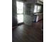 Bright kitchen area featuring white cabinets, a sink beneath a window, and a rustic door to the outdoors at 2822 S Dean Rd, Orlando, FL 32825