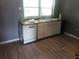 Kitchen features a window, sink, dishwasher, and simple cabinetry at 2822 S Dean Rd, Orlando, FL 32825