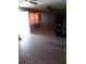 Open-concept living room area with tile flooring, ceiling fan, and a door to the outdoors at 2822 S Dean Rd, Orlando, FL 32825
