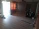 This living room features dark walls and laminate wood-style flooring at 2822 S Dean Rd, Orlando, FL 32825