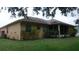 View of the back of the house with a screened-in lanai and a hose at 2913 Deerbrook Dr, Lakeland, FL 33811