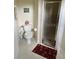 Cozy bathroom with a toilet, decorative wall art, and a glass enclosed shower at 2913 Deerbrook Dr, Lakeland, FL 33811