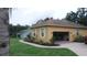 Single story home with an attached garage and walkway surrounded by landscaped garden at 2913 Deerbrook Dr, Lakeland, FL 33811