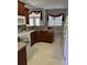 Bright kitchen featuring wood cabinetry and stainless steel appliances at 2913 Deerbrook Dr, Lakeland, FL 33811