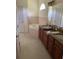 Bathroom featuring double vanity, soaking tub and tile flooring at 2913 Deerbrook Dr, Lakeland, FL 33811