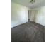 Cozy bedroom featuring plush gray carpeting, white walls, and a convenient closet at 2921 Crutchfield W Rd, Lakeland, FL 33805