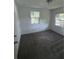 Clean bedroom featuring neutral carpet, and two bright windows enhancing natural light at 2921 Crutchfield W Rd, Lakeland, FL 33805