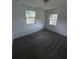 Bright bedroom featuring neutral carpet, with two bright windows at 2921 Crutchfield W Rd, Lakeland, FL 33805