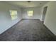 Spacious bedroom with plush gray carpeting and natural light from two windows at 2921 Crutchfield W Rd, Lakeland, FL 33805
