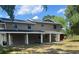 Two-story home featuring neutral siding, a covered front porch, and classic architectural design at 2921 Crutchfield W Rd, Lakeland, FL 33805