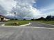 Scenic view of well-maintained community greenspace with lush landscaping and a nearby home at 3059 Sanctuary Cir, Lakeland, FL 33803
