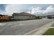 New home exterior with a neutral color scheme, tile roof, and a spacious street view at 3059 Sanctuary Cir, Lakeland, FL 33803