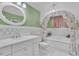 The bathroom has a decorative motif, green walls, and decorative mirror at 3450 Ohio Ave, Sanford, FL 32773