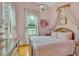 A well lit bedroom boasts high ceilings, canopy, and a pretty floral motif at 3450 Ohio Ave, Sanford, FL 32773