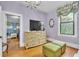The airy bedroom shows a decorative dresser, hardwood floors, and a bright window at 3450 Ohio Ave, Sanford, FL 32773
