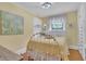 A sunny bedroom has a yellow wall, large window, and hardwood floor at 3450 Ohio Ave, Sanford, FL 32773