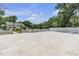 Extensive paved driveway and parking area with white picket fence and verdant lawn at 3450 Ohio Ave, Sanford, FL 32773