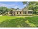 Charming yellow home with a manicured lawn and inviting front porch, perfect for relaxing outdoors at 3450 Ohio Ave, Sanford, FL 32773