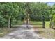 Ornate metal gate with a circular emblem adds elegance to the property's entrance at 3450 Ohio Ave, Sanford, FL 32773