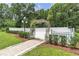 Charming heart-shaped trellis with brick walkway and white picket fence at 3450 Ohio Ave, Sanford, FL 32773
